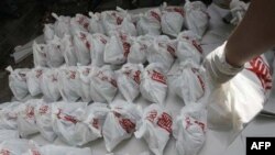 A rescue worker arranges bags containing dead fetuses found at the morgue of a Buddhist temple in Bangkok, Thailand, Friday, Nov. 19, 2010. Thai police have discovered hundreds of human fetuses dumped at the morgue during an investigation that began Tuesd