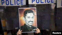 A protester holds a picture of Bahraini rights activist Abdulhadi al-Khawaja during an anti-government rally demanding his release, Manama, April 18, 2012. 