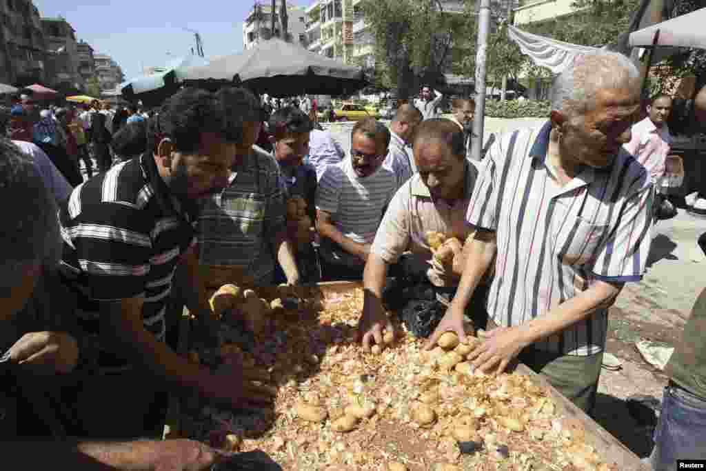 Warga membeli kentang dari penjual di pinggir jalan Karaj Al-Hajez, Aleppo, Suriah.&nbsp;