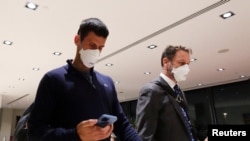 Serbian tennis player Novak Djokovic walks in Melbourne Airport before boarding a flight, after the Federal Court upheld a government decision to cancel his visa to play in the Australian Open, in Melbourne, Australia, January 16, 2022.