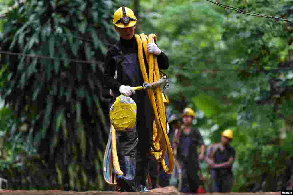 Military personnel carries diving cables out from Tham Luang cave complex, as members of an under-16 soccer team and their coach have been found alive according to local media in the northern province of Chiang Rai, Thailand.