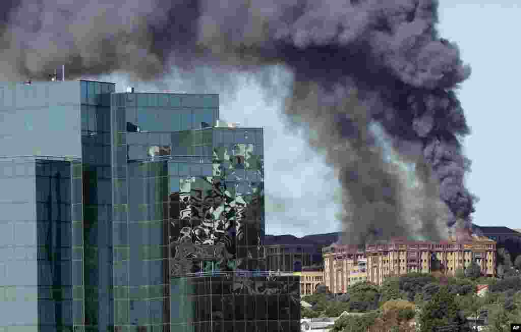 Flames engulf the top floor of an office building in Johannesburg, South Africa, before being bought under control.