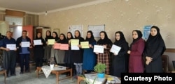 A picture sent to VOA's Kurdish Service by an Iranian education activist shows teachers holding protest signs at a school in the city of Marivan in Iran's Kurdistan province, Nov. 14, 2018.