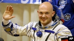 FILE - European Space Agency's astronaut Alexander Gerst, crew member of the mission to the International Space Station, waves during inspection of his space suit prior to the launch of the Soyuz-FG rocket at the Russian-leased Baikonur cosmodrome, Kazakhstan, May 28, 2014.