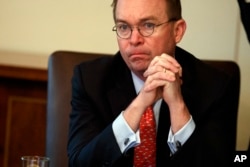FILE - Acting White House chief of staff Mick Mulvaney listens as President Donald Trump speaks during a cabinet meeting at the White House in Washington, Jan. 2, 2019.
