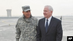 General Petraeus, Commander of ISAF Afghanistan, chats with US Defense Secretary Gates upon Gates' arrival in Kabul, March 7, 2011