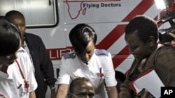 An unidentified Medecins Sans Frontieres (MSF) driver is assisted from an ambulance as he arrives at the Nairobi hospital in Kenya's capital Nairobi, October 13, 2011