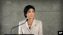 FILE - Thailand Prime Minister Yingluck Shinawatra pauses as she talks to media after attending a Cabinet meeting, in Bangkok.