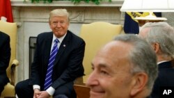 FILE - President Donald Trump and Senate Democratic Minority Leader Chuck Schumer are seen during a meeting with other Congressional leaders in the Oval Office of the White House in Washington, Sept. 6, 2017.
