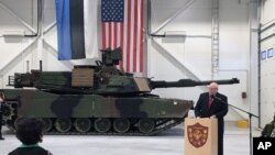 FILE - U.S. Ambassador to Estonia James D. Melville Jr. addresses dignitaries in front of an U.S. Army tank, at a hand-over ceremony of the upgraded NATO military base in Tapa, Estonia, Thursday, Dec. 15, 2016. 
