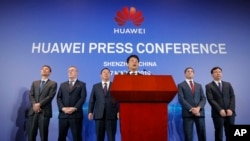 Huawei Rotating Chairman Guo Ping, center, speaks in front of other executives during a press conference in Shenzhen, China's Guangdong province, March 7, 2019.