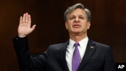FILE - FBI Director nominee Christopher Wray is sworn-on on Capitol Hill in Washington, July 12, 2017, prior to testifying at his confirmation hearing before the Senate Judiciary Committee. 