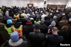 People gather for funeral prayers for the victims of the Twin Parks North West multi-level apartment building fire, at the Islamic Cultural Center in the Bronx borough of New York City, Jan. 16, 2022.