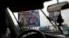 A poster featuring Congo's current President Joseph Kabila with ruling party candidate and former interior minister Emmanuel Ramazani Shadary is displayed on the road leading to the airport in Kinshasa, Democratic Republic of the Congo, Dec. 17, 2018. 