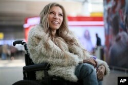 FILE - In this file photo dated March 14, 2017, Russian singer Yulia Samoylova who was chosen to represent Russia in the 2017 Eurovision Song Contest, poses while sitting in a wheelchair at Sheremetyevo airport outside Moscow, Russia.