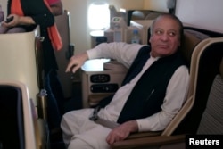 Ousted Pakistani Prime Minister Nawaz Sharif sits on a plane after landing at the Allama Iqbal International Airport in Lahore, Pakistan, July 13, 2018.