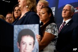 President Donald Trump listens during an event on immigration alongside family members affected by crime committed by undocumented immigrants, at the South Court Auditorium in the White House complex, June 22, 2018, in Washington.