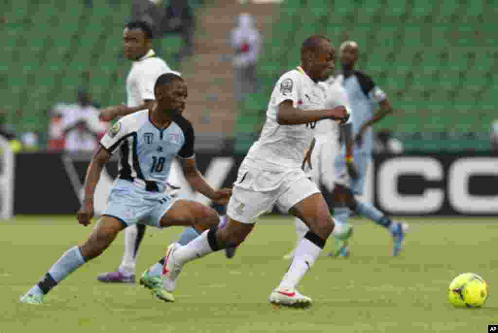 Ghana's Andre Ayew (R) challenges Mogogi Gabonamong of Botswana during their African Cup of Nations Group D soccer match in FranceVille Stadium January 24, 2012.