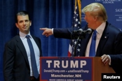 FILE - Then U.S. Republican presidential candidate Donald Trump welcomes his son Donald Trump Jr. to the stage at a campaign event in Manchester, New Hampshire November 11, 2015.