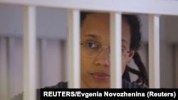 FILE: U.S. basketball player Brittney Griner stands inside a defendants' cage during the reading of the court's verdict in Khimki outside Moscow 8.4.2022