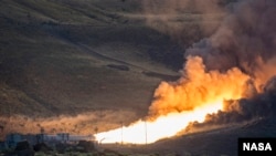 The second and final qualification motor (QM-2) test for the Space Launch System’s booster is seen, June 28, 2016, at Orbital ATK Propulsion System's (SLS) test facilities in Promontory, Utah. During the SLS flight the boosters will provide more than 75 percent of the thrust needed to escape the gravitational pull of the Earth, the first step on NASA’s Journey to Mars. Photo Credit: (NASA/Bill Ingalls)