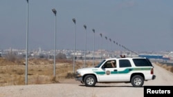 FILE - A U.S. Border Patrol truck sits at the U.S.-Mexico border in El Paso, Texas. 