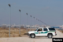 FILE - A U.S. Border Patrol truck sits at the U.S.-Mexico border in El Paso, Texas.