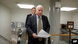 Senator John McCain, a member of the Senate Foreign Relations Committee, heads to the chamber to advance a bill providing $1 billion in loan guarantees to Ukraine, March 24, 2014. 