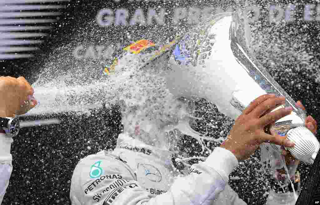 Mercedes driver Lewis Hamilton of Britain celebrates on the podium after winning the Spain Formula One Grand Prix at the Barcelona Catalunya racetrack in Montmelo, near Barcelona, Spain.