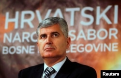 FILE - Newly elected President of Croatian National Parliament and President of HDZ political party (Croatian Democratic Union) Dragan Covic listens during a news conference after a meeting in Mostar, April 19, 2011.