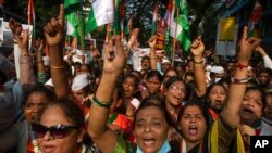 FILE - Supporters of India's main opposition Congress shout slogans during in a nationwide agitation against unemployment, inflation and price hike of essential commodities in Mumbai, Nov. 14, 2021.