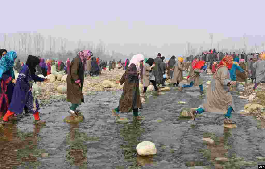 Kashmiri villagers arrive for the funeral procession of militant Tanveer Ahmed and resident Ruby Jan at Batmurran Kellar village in Shopian.