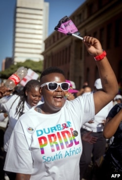 FILE - A woman chants slogans as members of the South African Lesbian, Gay, Bisexual and Transgender and Intersex (LGBTI) community take part in the annual Gay Pride Parade, as part of the three-day Durban Pride Festival, on June 24, 2017 in Durban.