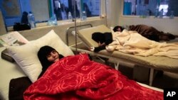 FILE - Women are treated for a suspected cholera infection at a hospital in Sana'a, Yemen, May 15, 2017.