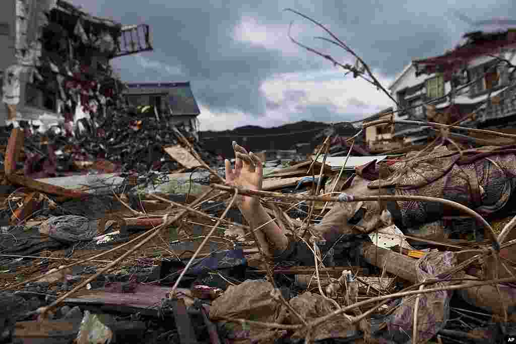 The arm of a mannequin sticks out from the rubble in a devastated neighborhood in Kesennuma, Miyagi prefecture, in northeastern Japan, May 30, 2011. (AP)