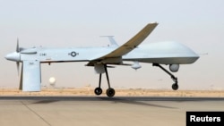 FILE - An MQ-1B Predator from the 46th Expeditionary Reconnaissance Squadron takes off from Balad Air Base in Iraq.