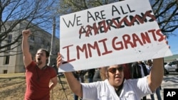 Protesters chant outside the Grayson County courthouse in Sherman, Texas, Feb. 16, 2017. In an action called "A Day Without Immigrants," immigrants across the country are expected to stay home from school, work and close businesses to show how critical they are to the U.S. economy and way of life. 