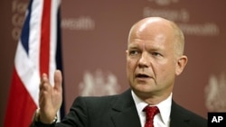 British Foreign Minister William Hague address the media during a news conference at the Foreign and Commonwealth Office in London, July 27, 2011