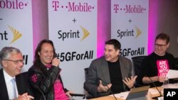 T-Mobile and Sprint executives enjoy a laugh as they accounce the two companies' planned merger April 29, 2018, in New York.