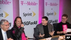 T-Mobile and Sprint executives enjoy a laugh as they accounce the two companies' planned merger April 29, 2018, in New York.