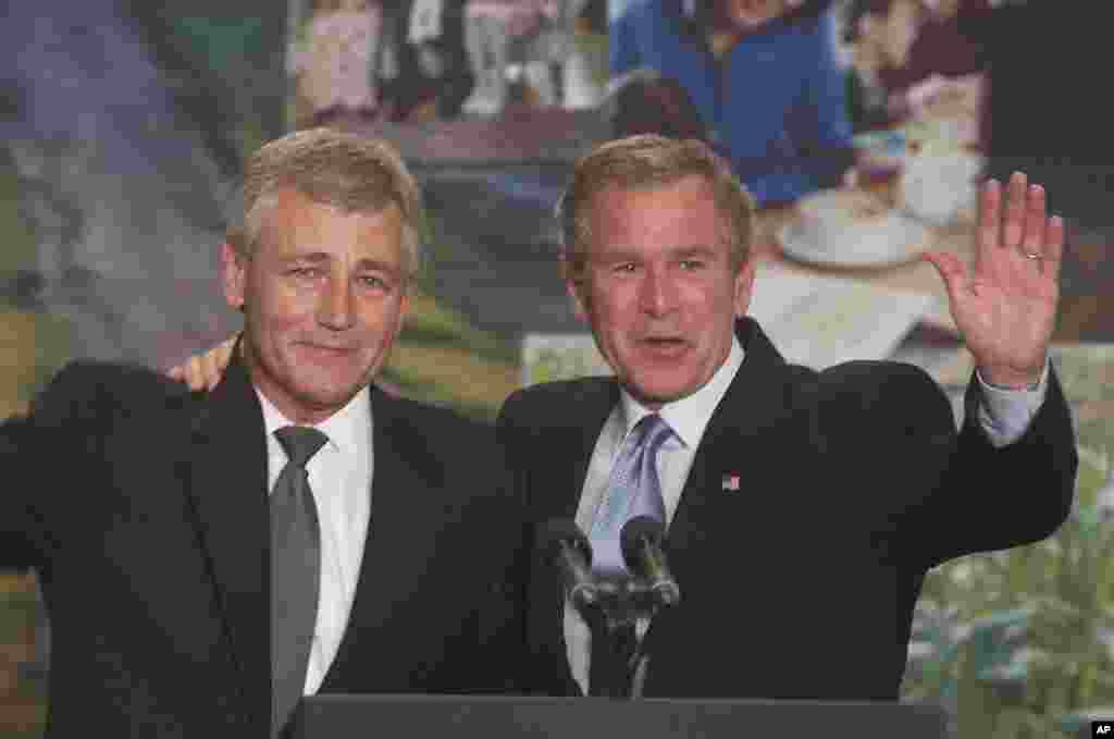 Then President George W. Bush and then Senator Chuck Hagel embrace at the Airlite Plastics Company in Omaha, Nebraska, May 12, 2003.