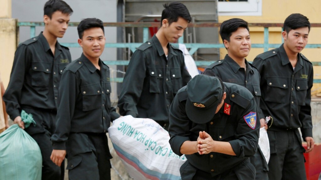 Trung đoàn phó Trung đoàn Cảnh sát cơ động Phạm Văn Trung chắp tay, cúi đầu nhiều lần hướng về phía nhiều người dân đứng xem.