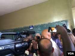 Haiti's President Michel Martelly on his way to vote at a polling station in Petion-Ville, Haiti, Oct. 25, 2015. (J. Belizaire/VOA)