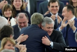 Newly elected European Parliament President Antonio Tajani is congratulated by members of the Parliament, Jan. 17, 2017.