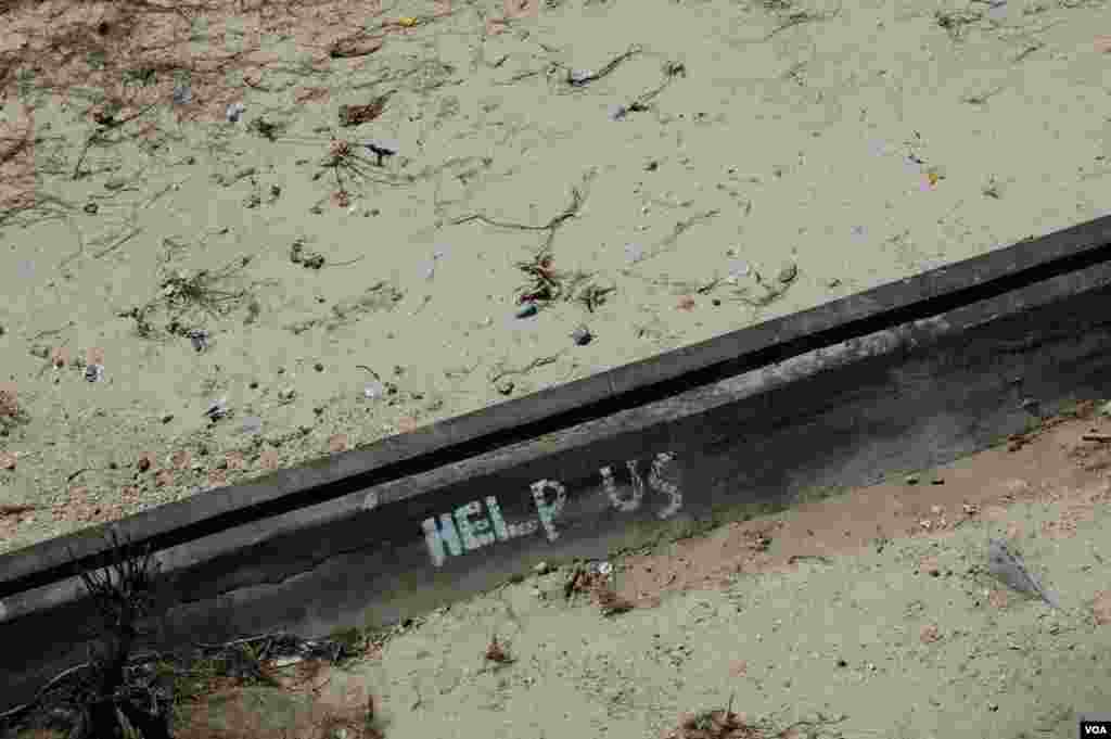 A plea for assistance to those flying overhead in Eastern Samar province, Philippines, Nov. 19, 2013. (Steve Herman/VOA) 