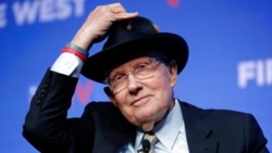 FILE - Former U.S. Sen. Harry Reid tips his hat during a fundraiser for the Nevada Democratic Party, on Nov. 17, 2019, in Las Vegas.