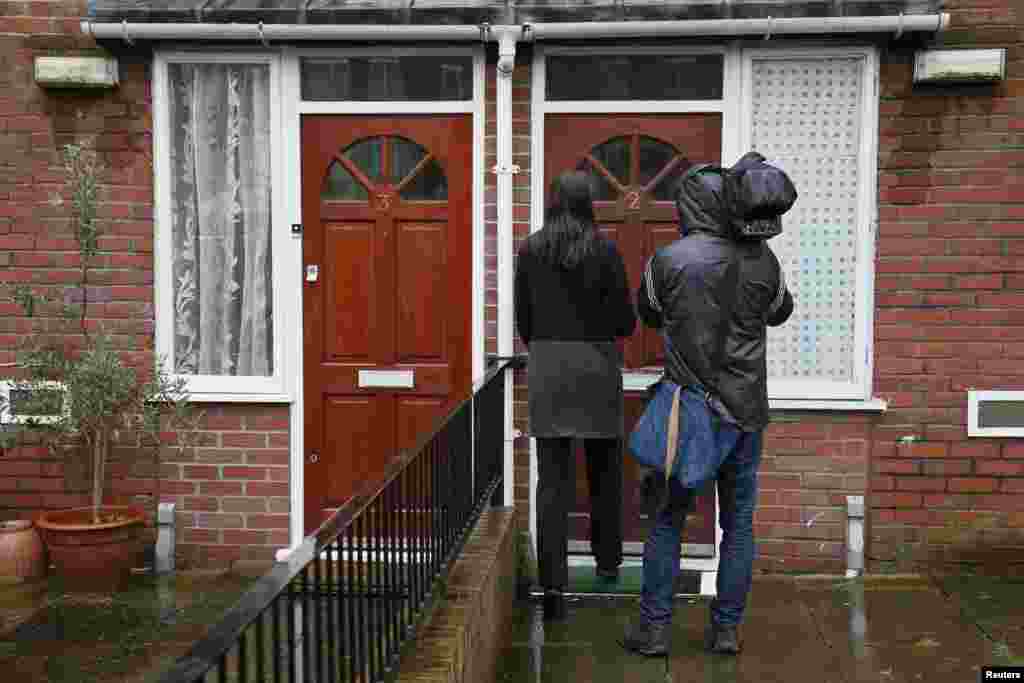 Media stand outside a flat in London, February 26, 2015. Local media reported that the flat is the former home of Mohammed Emwazi, the &quot;Jihadi John&quot; masked fighter who fronted Islamic State militant beheading videos.