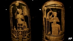 Ancient Egyptian shields made of wood covered with gesso and gold leaf are displayed in a glass case during the exhibition of Tutankhamun's unseen treasures marking the 115th anniversary of the Egyptian museum in Cairo, Egypt, Nov. 15, 2017.