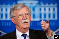 FILE - National security adviser John Bolton speaks to reporters during the daily press briefing at the White House.
