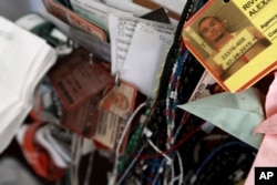 FILE - Dozens of deportee bracelets hang from a cross inside a migrant shelter in Ciudad Juarez, Mexico, Nov. 14, 2016.